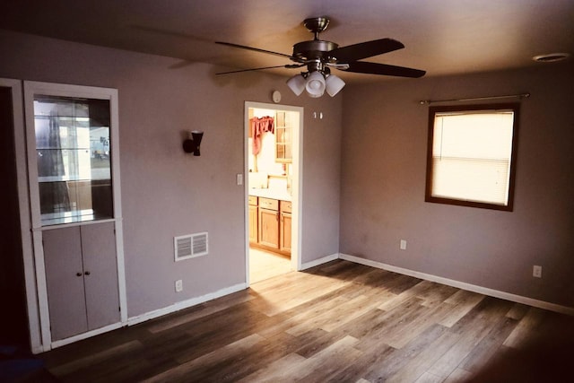 2218 Jerome Blvd, Racine, WI 53403 - spare room featuring ceiling fan, wood finished floors, and healthy amount of natural light