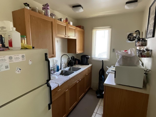 1920 N 7th St, Sheboygan, WI 53081 - kitchen with freestanding refrigerator, light countertops, and light tile patterned floors