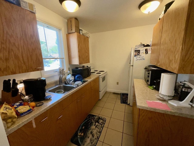 1920 N 7th St, Sheboygan, WI 53081 - kitchen featuring white appliances, brown cabinetry, light tile patterned floors, and light countertops