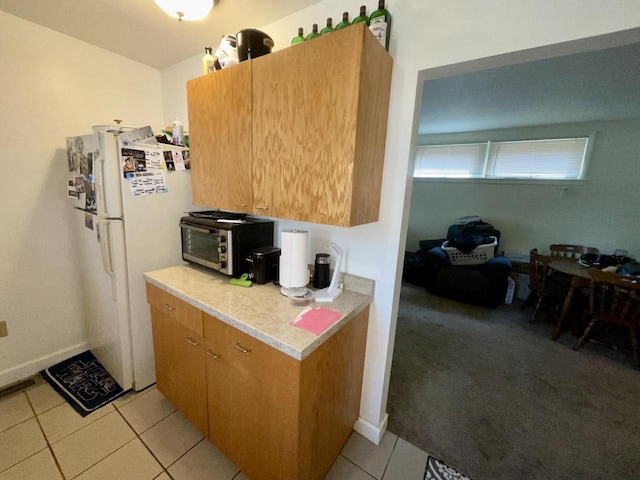 1920 N 7th St, Sheboygan, WI 53081 - kitchen featuring freestanding refrigerator, light tile patterned floors, and light countertops