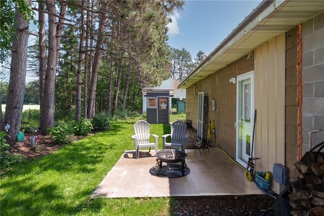 4271 220th St, Cadott, WI 54727 - view of green lawn with a patio, a fire pit, and a storage unit