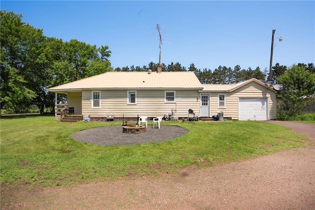 4271 220th St, Cadott, WI 54727 - rear view of house featuring a yard, an attached garage, asphalt driveway, and a metal roof