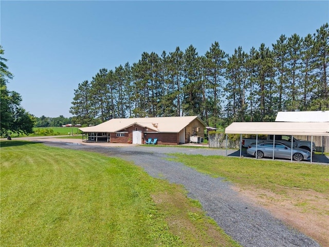 4271 220th St, Cadott, WI 54727 - view of front of property with a detached carport, a front yard, and driveway