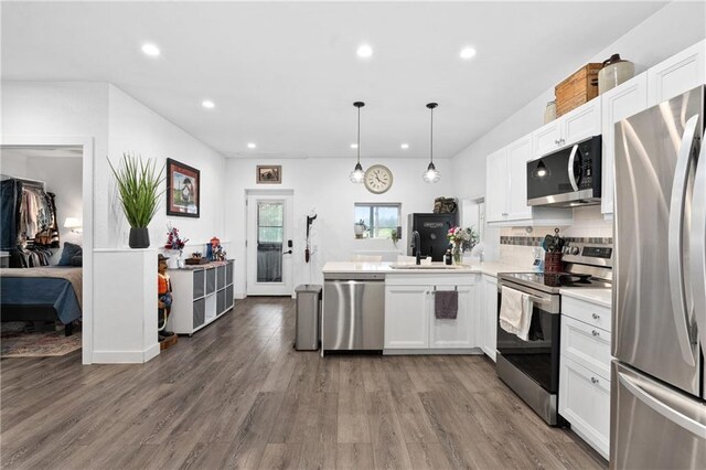 4271 220th St, Cadott, WI 54727 - kitchen featuring stainless steel appliances, recessed lighting, white cabinetry, a peninsula, and light countertops