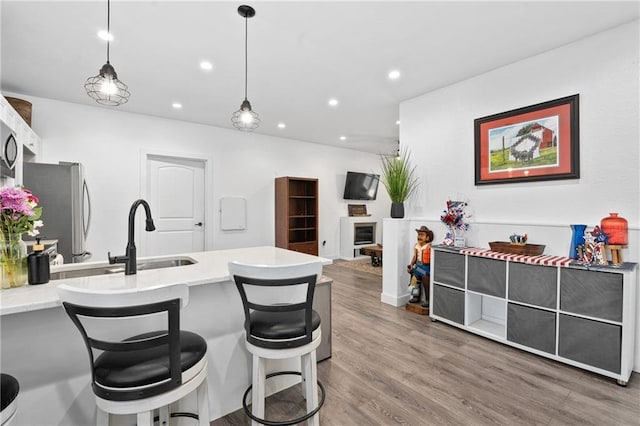 4271 220th St, Cadott, WI 54727 - kitchen featuring freestanding refrigerator, a peninsula, recessed lighting, a breakfast bar, and hanging light fixtures