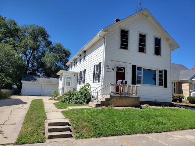 1834 N 21st St, Sheboygan, WI 53081 - view of front facade featuring a front lawn, an outbuilding, and a garage