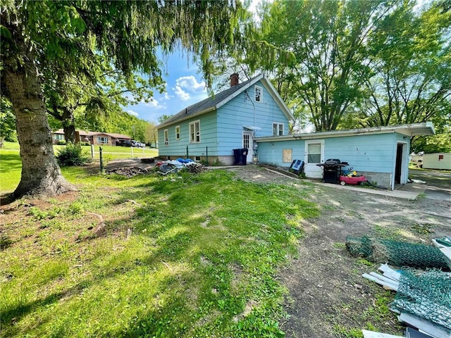 306 E Race Ave, Elmwood, WI 54740 - view of property exterior featuring a yard and a chimney