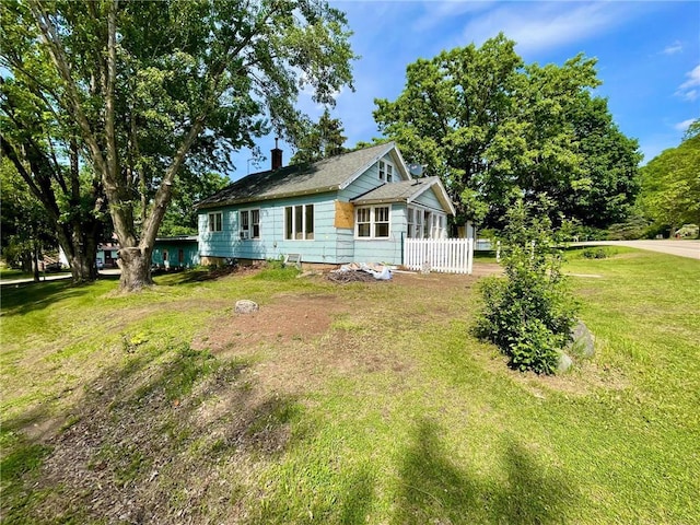 306 E Race Ave, Elmwood, WI 54740 - view of front of home featuring a front lawn and a chimney