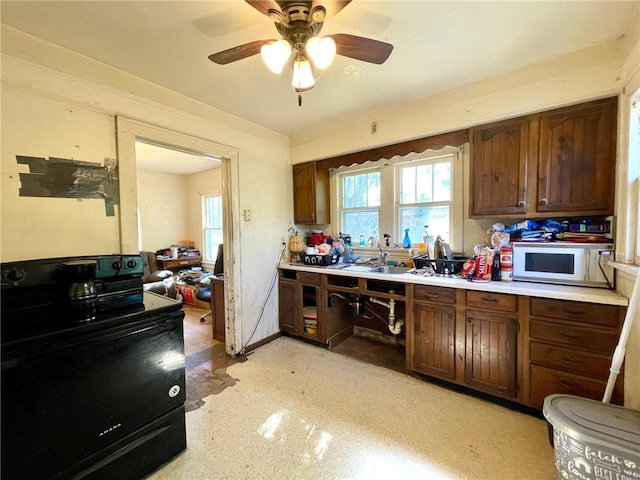 306 E Race Ave, Elmwood, WI 54740 - kitchen featuring white microwave, black electric range, light countertops, and healthy amount of natural light