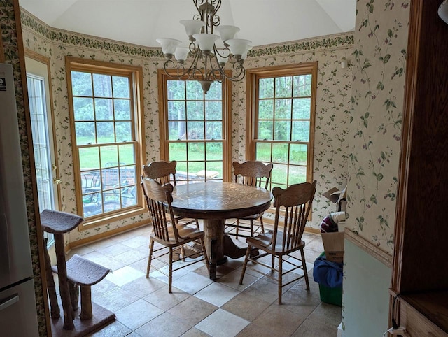 1817 S Duck Creek Dr, Friendship, WI 53934 - dining space featuring wallpapered walls, lofted ceiling, a chandelier, and plenty of natural light
