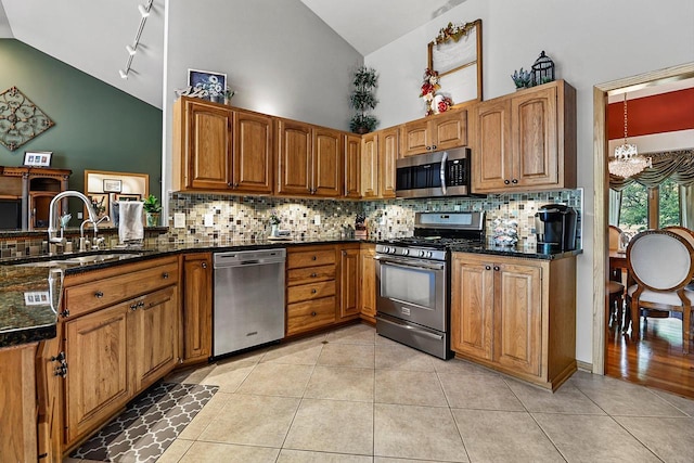6320 10th Pl, Kenosha, WI 53144 - kitchen featuring stainless steel appliances, a chandelier, high vaulted ceiling, light tile patterned floors, and tasteful backsplash