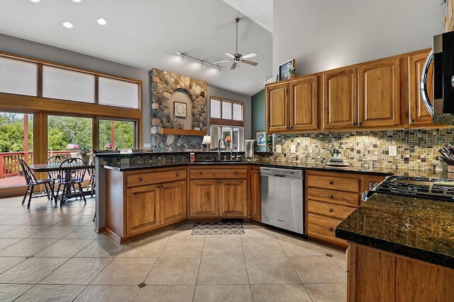 6320 10th Pl, Kenosha, WI 53144 - kitchen with appliances with stainless steel finishes, a ceiling fan, brown cabinetry, light tile patterned floors, and a peninsula