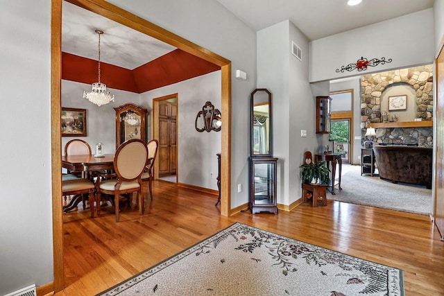 6320 10th Pl, Kenosha, WI 53144 - dining room featuring wood finished floors, a fireplace, and a chandelier