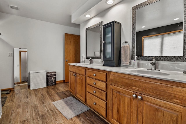 6320 10th Pl, Kenosha, WI 53144 - bathroom featuring double vanity and wood finished floors