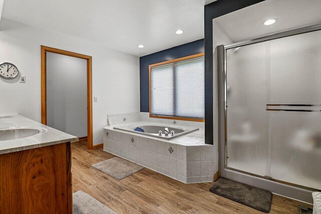 6320 10th Pl, Kenosha, WI 53144 - bathroom with a garden tub, a shower stall, wood finished floors, double vanity, and recessed lighting