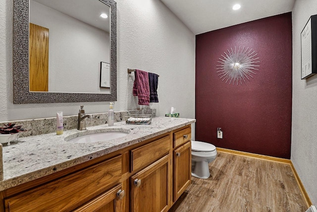 6320 10th Pl, Kenosha, WI 53144 - bathroom with wood finished floors, a textured wall, vanity, and recessed lighting