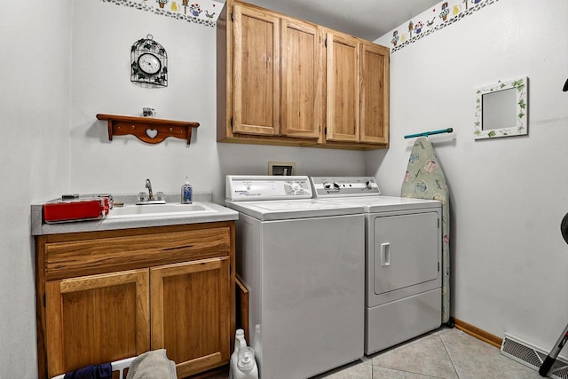 6320 10th Pl, Kenosha, WI 53144 - washroom with cabinet space, light tile patterned flooring, and washer and dryer