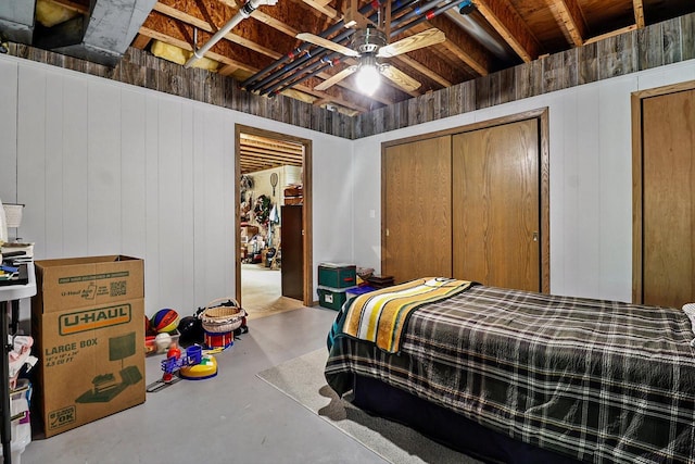 6320 10th Pl, Kenosha, WI 53144 - bedroom with finished concrete floors, wooden walls, and ceiling fan