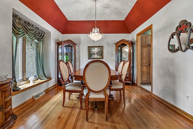 6320 10th Pl, Kenosha, WI 53144 - dining room with light wood-type flooring, a chandelier, and lofted ceiling