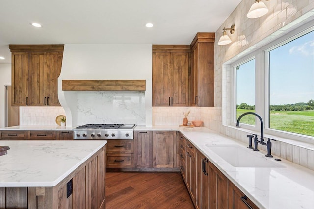 3330 Colton Way, Sun Prairie, WI 53590 - kitchen featuring gas stovetop, recessed lighting, light stone counters, dark wood-style floors, and brown cabinetry