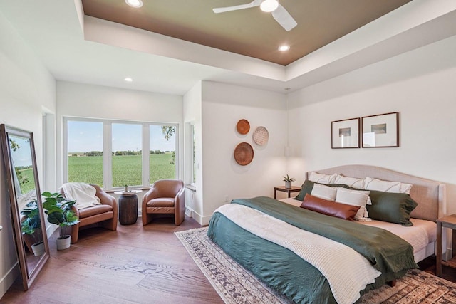 3330 Colton Way, Sun Prairie, WI 53590 - bedroom featuring wood finished floors, a tray ceiling, recessed lighting, and ceiling fan