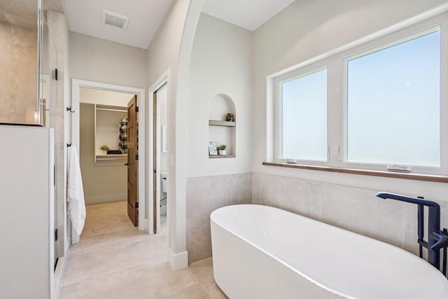 3330 Colton Way, Sun Prairie, WI 53590 - full bathroom with a freestanding bath, tile patterned floors, a spacious closet, and a shower