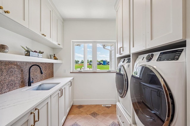 3330 Colton Way, Sun Prairie, WI 53590 - laundry area with washing machine and clothes dryer and cabinet space
