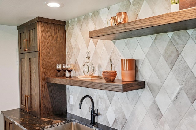 3330 Colton Way, Sun Prairie, WI 53590 - kitchen featuring dark stone countertops and decorative backsplash