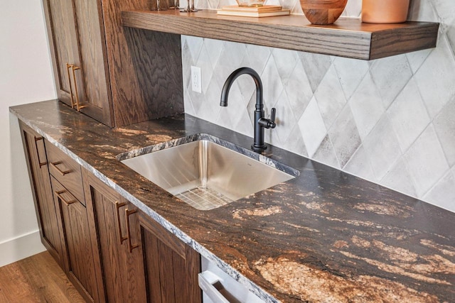 3330 Colton Way, Sun Prairie, WI 53590 - kitchen featuring tasteful backsplash, dark stone countertops, brown cabinetry, and wood finished floors