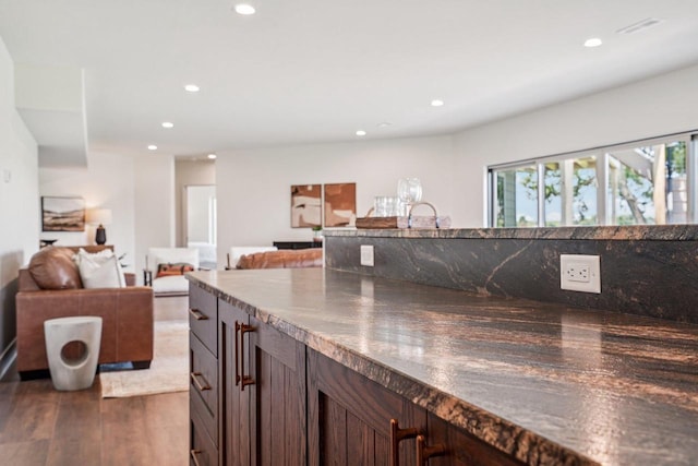 3330 Colton Way, Sun Prairie, WI 53590 - kitchen with recessed lighting, dark brown cabinets, dark wood-style floors, open floor plan, and dark countertops