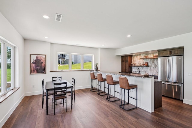 3330 Colton Way, Sun Prairie, WI 53590 - kitchen featuring freestanding refrigerator, open shelves, plenty of natural light, a kitchen breakfast bar, and recessed lighting
