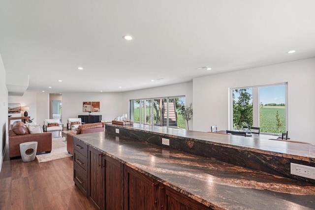 3330 Colton Way, Sun Prairie, WI 53590 - kitchen featuring recessed lighting, dark wood-style floors, dark brown cabinetry, and dark stone counters