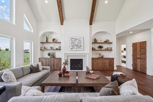 3330 Colton Way, Sun Prairie, WI 53590 - living area featuring built in shelves, dark wood finished floors, a fireplace, a towering ceiling, and recessed lighting