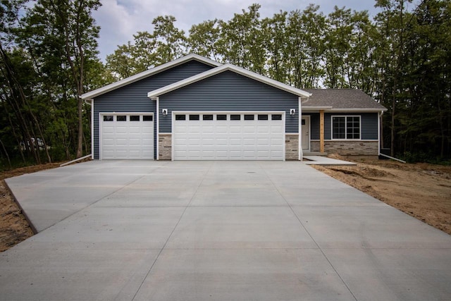 219 Joe St, Stevens Point, WI 54481 - ranch-style house with an attached garage, stone siding, and concrete driveway