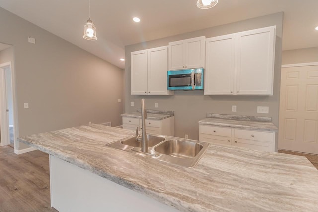 219 Joe St, Stevens Point, WI 54481 - kitchen featuring stainless steel microwave, white cabinetry, decorative light fixtures, wood finished floors, and recessed lighting