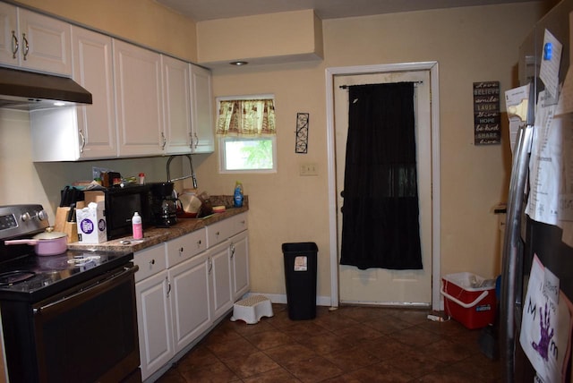 741 Vernon Ave, Beloit, WI 53511 - kitchen with electric range, white cabinets, under cabinet range hood, and dark tile patterned flooring