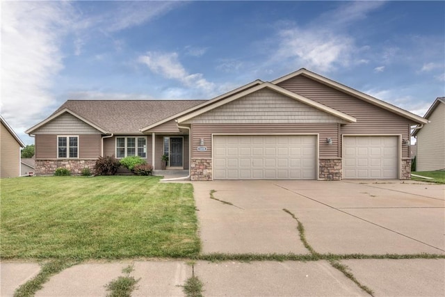 1814 Lynnette Ct, Eau Claire, WI 54703 - view of front facade with stone siding, an attached garage, driveway, and a front lawn