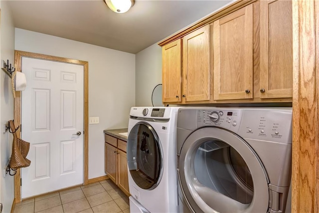 1814 Lynnette Ct, Eau Claire, WI 54703 - washroom with cabinet space, separate washer and dryer, and light tile patterned flooring