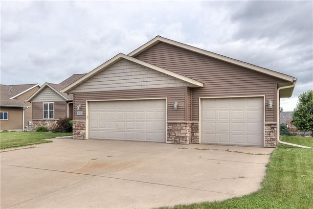 1814 Lynnette Ct, Eau Claire, WI 54703 - view of front of home with stone siding, concrete driveway, and a garage