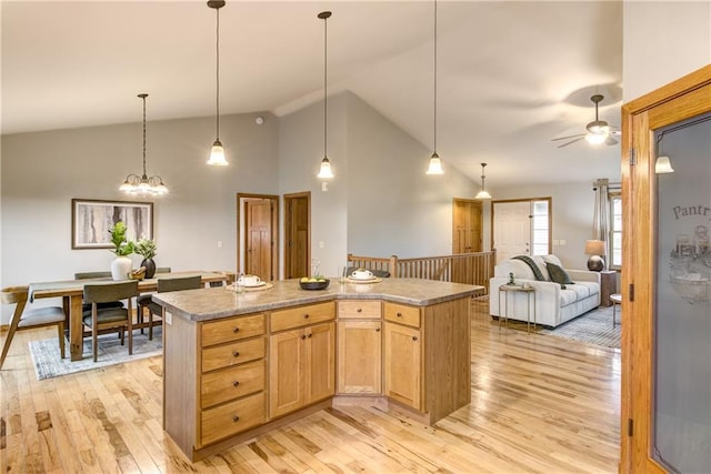 1814 Lynnette Ct, Eau Claire, WI 54703 - kitchen with light wood-style floors, ceiling fan, a kitchen island, open floor plan, and high vaulted ceiling
