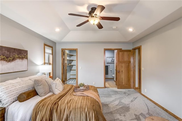 1814 Lynnette Ct, Eau Claire, WI 54703 - bedroom with a tray ceiling, a walk in closet, ensuite bathroom, light carpet, and recessed lighting