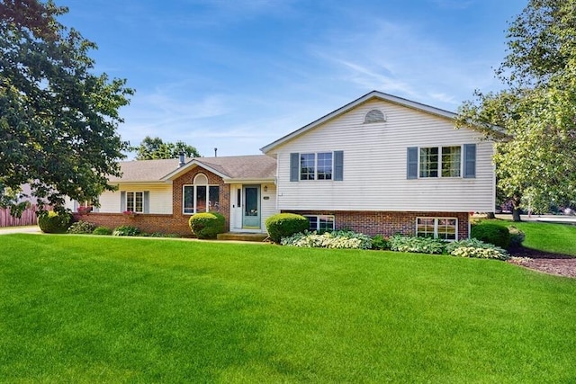 701 Devils Ln, Walworth, WI 53184 - tri-level home with a front lawn and brick siding
