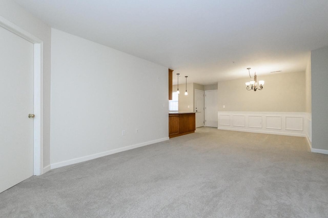 18520 Emerald Cir Unit D, Brookfield, WI 53045 - unfurnished living room featuring a chandelier and light colored carpet