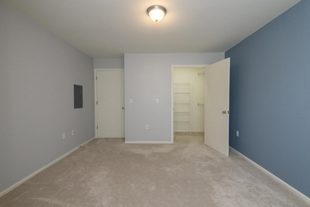 18520 Emerald Cir Unit D, Brookfield, WI 53045 - unfurnished bedroom with electric panel, light carpet, a spacious closet, and a closet