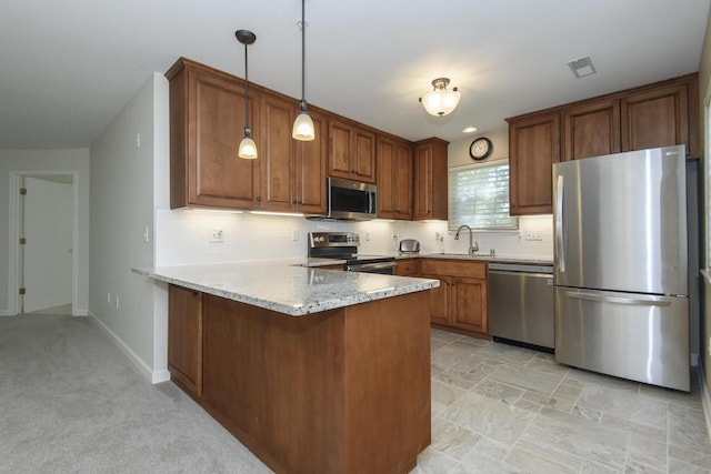 18520 Emerald Cir Unit D, Brookfield, WI 53045 - kitchen featuring stainless steel appliances, a peninsula, brown cabinets, tasteful backsplash, and pendant lighting