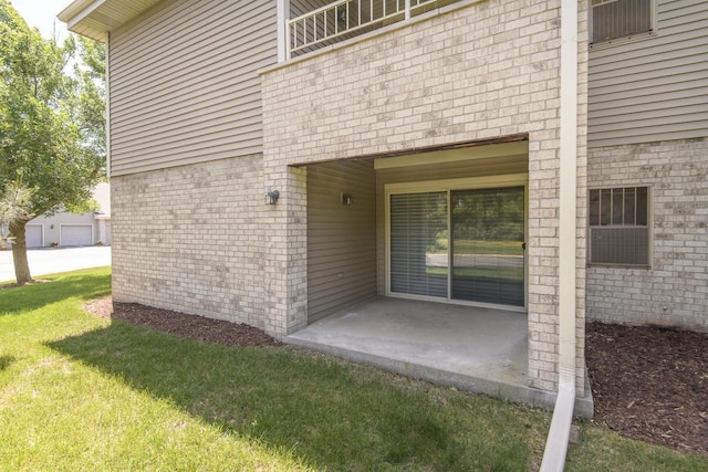 18520 Emerald Cir Unit D, Brookfield, WI 53045 - entrance to property featuring a lawn, a patio, and brick siding