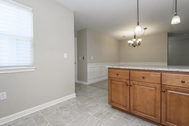 18520 Emerald Cir Unit D, Brookfield, WI 53045 - kitchen featuring brown cabinetry, light stone counters, hanging light fixtures, light stone finish floors, and a chandelier