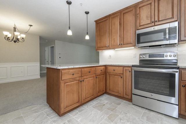 18520 Emerald Cir Unit D, Brookfield, WI 53045 - kitchen with appliances with stainless steel finishes, brown cabinetry, a peninsula, tasteful backsplash, and a chandelier
