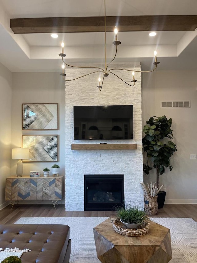 W214N6683 Fairview Dr, Menomonee Falls, WI 53051 - living room with wood finished floors, beam ceiling, a stone fireplace, and a tray ceiling