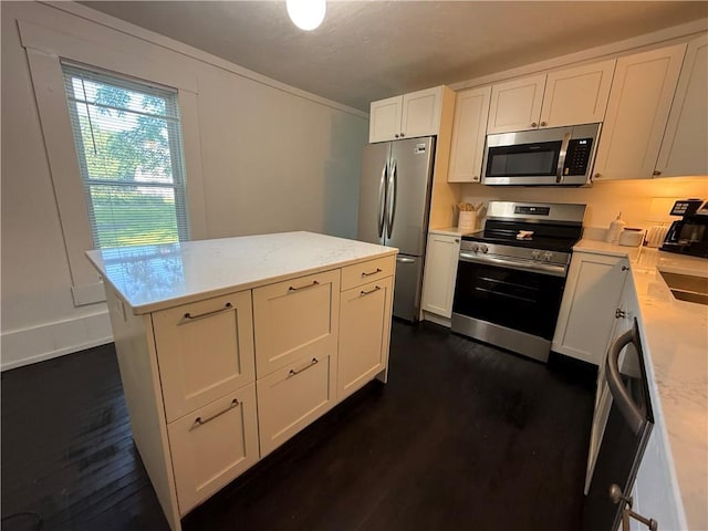 15 S Culver St, Chippewa Falls, WI 54729 - kitchen featuring stainless steel appliances, dark wood finished floors, white cabinets, and a kitchen island